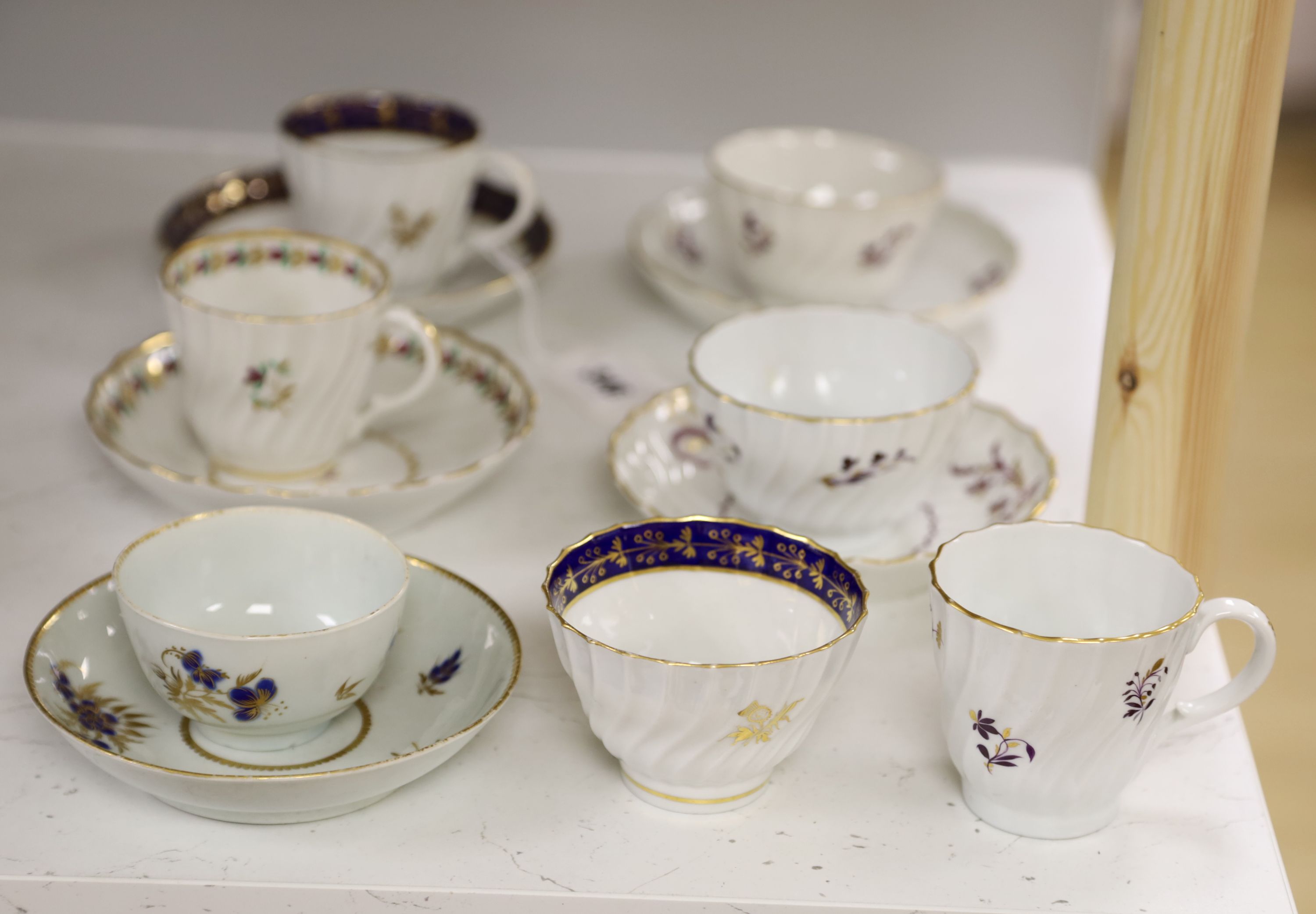 Two Flight trios, two teabowls and saucers and a coffee cup and saucer